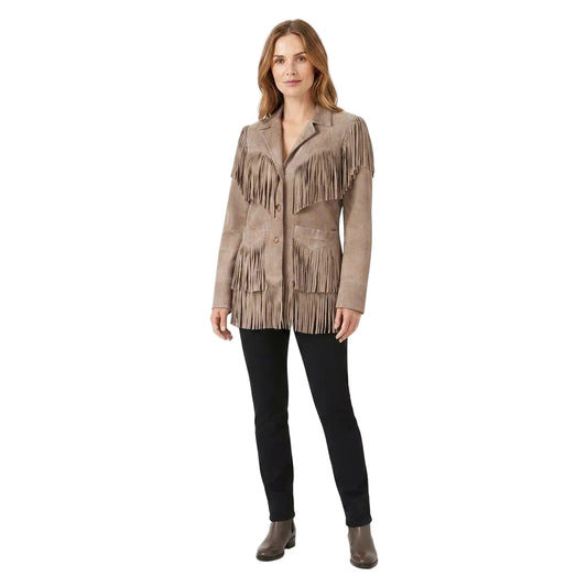 A woman modeling a taupe-brown suede fringe jacket with black pants and brown ankle boots, standing against a plain white studio background.