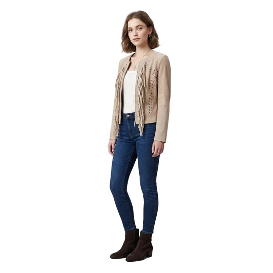 Woman wearing a beige jacket with lace-up details, blue jeans, and brown boots on a white background