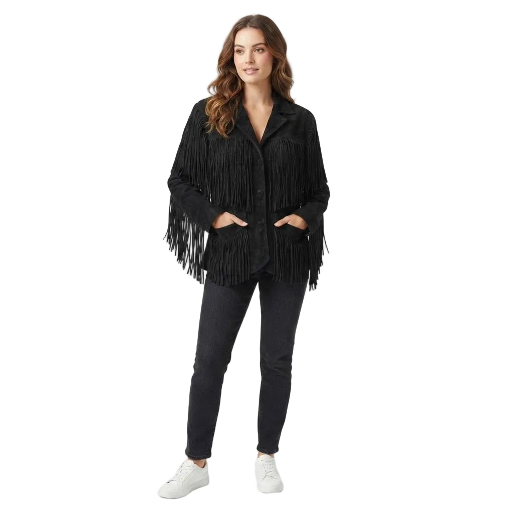 A woman modeling a black fringed jacket with a button-up front, paired with dark gray skinny jeans and white sneakers, against a solid white studio background.