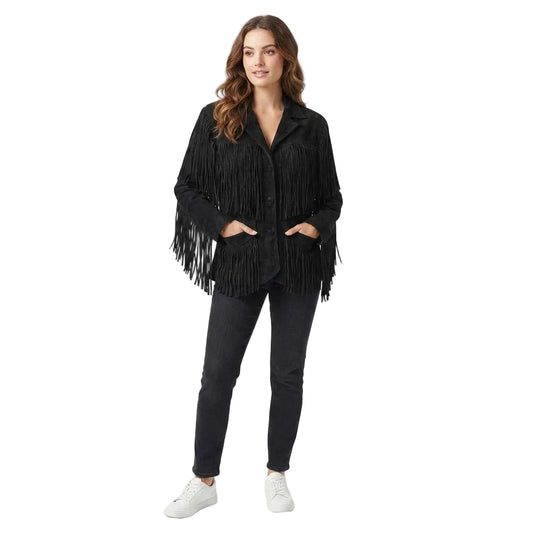 A woman modeling a black fringed jacket with a button-up front, paired with dark gray skinny jeans and white sneakers, against a solid white studio background.