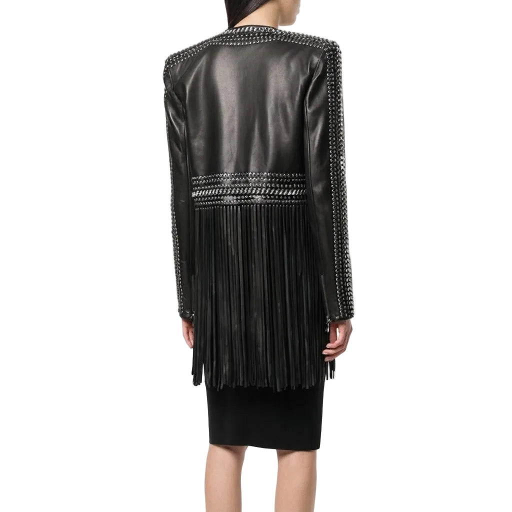 A model shown from the back wearing a black leather jacket with silver chain embellishments along the shoulders, sleeves, and waist, paired with a black skirt, against a plain white background.