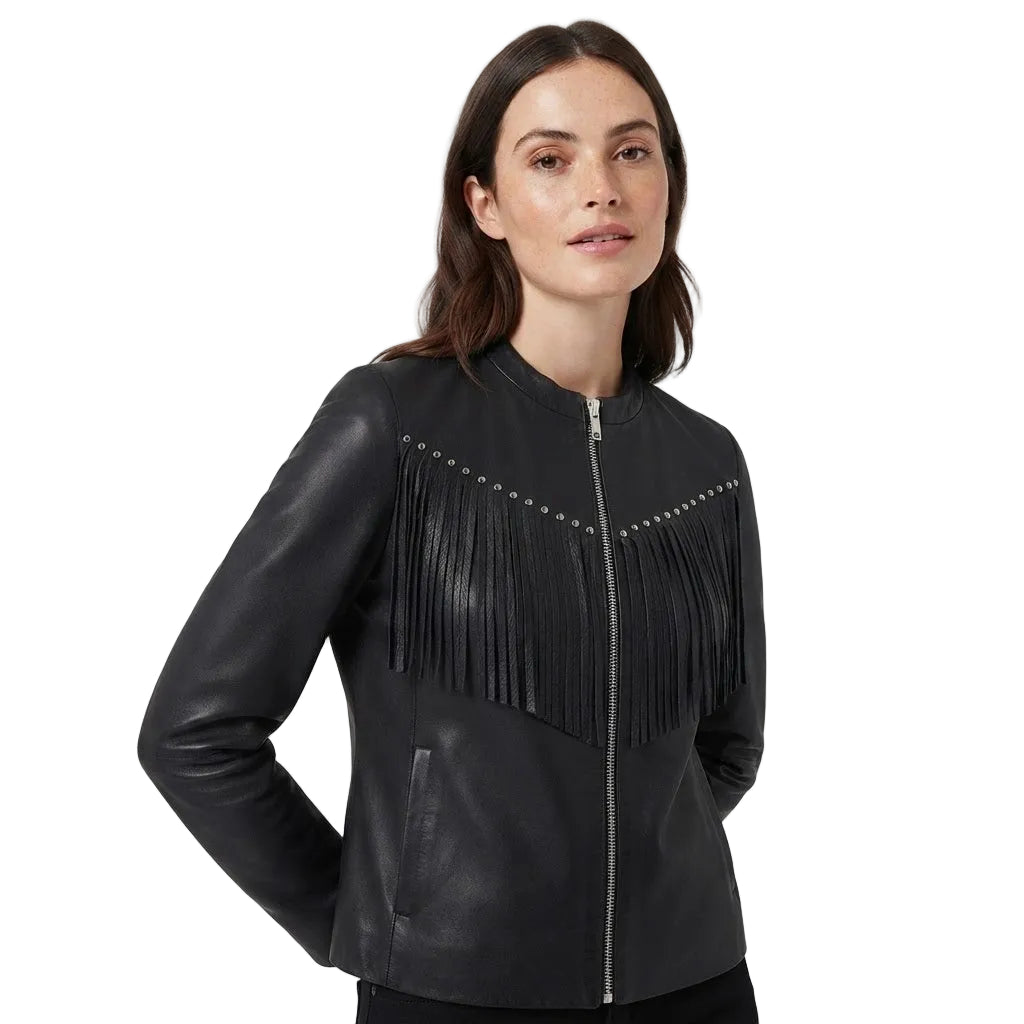 A woman wearing a black faux-leather fringe jacket with silver studs and a front zipper, photographed against a light gray studio background.