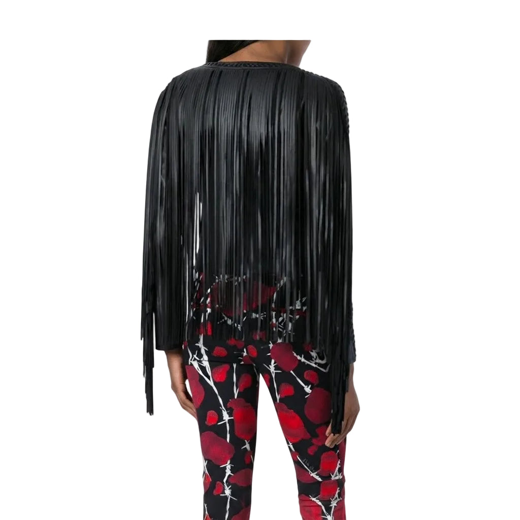 A model shown from the back wearing a black long-sleeve top with dramatic fringe and red-and-black patterned leggings against a plain white studio background.