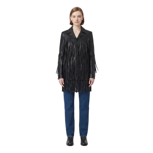 A model stands against a plain white studio background wearing a black leather fringe jacket, blue jeans, and black shoes.
