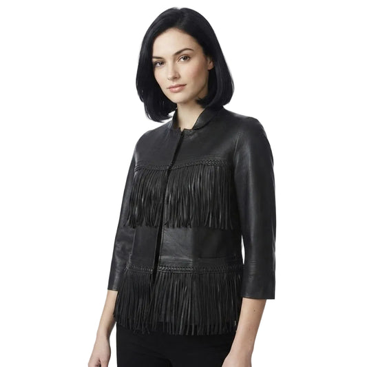 A woman modeling a black leather jacket with fringe detailing on the front, set against a plain white background.