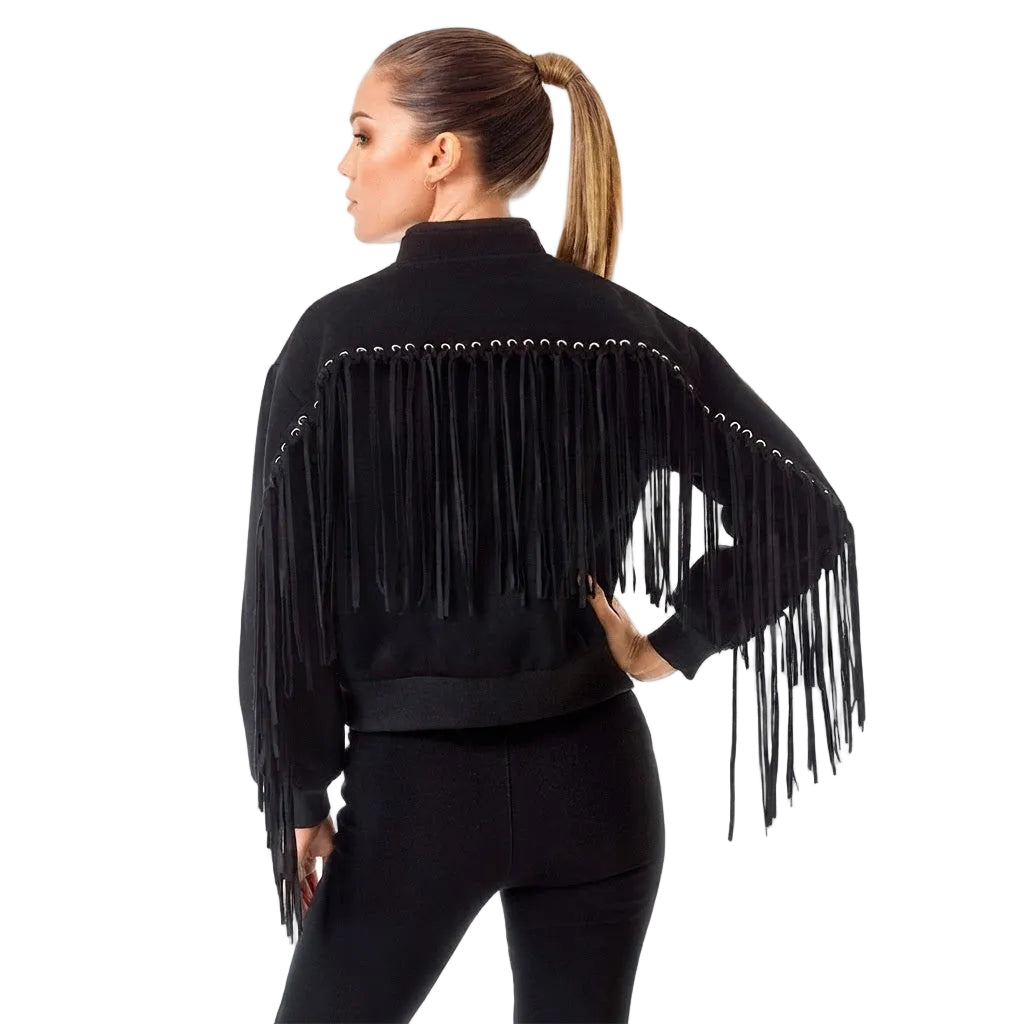 A woman shown from the back wearing a black fringed jacket with long fringe across the shoulders and sleeves, paired with black pants, against a plain white background.