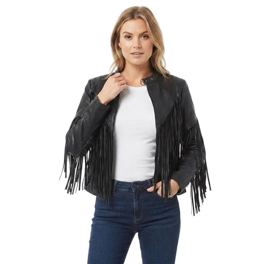 A woman modeling a black faux-leather fringe jacket over a white top and blue jeans, photographed against a plain white studio background.