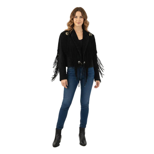 Woman wearing a black fringed jacket, blue jeans, and black boots on a white background