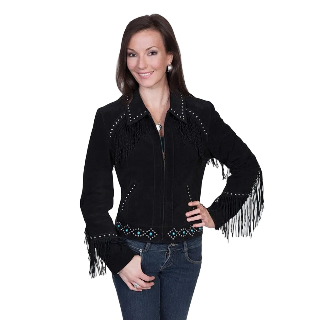 A woman modeling a black suede fringe jacket with turquoise and silver beadwork details, paired with dark blue jeans, against a plain white studio background.