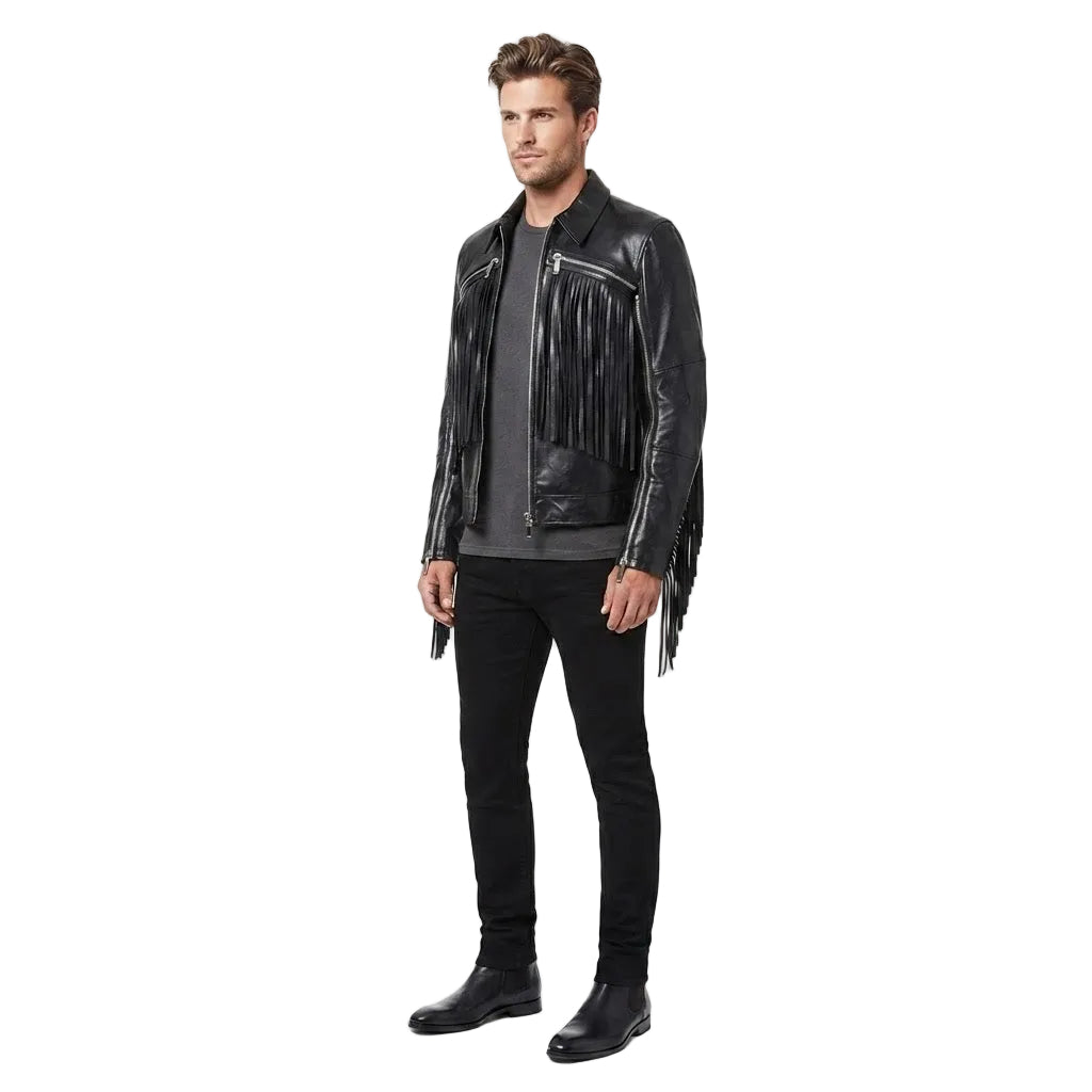 A man modeling a black leather fringe jacket over a dark gray t-shirt, black jeans, and black boots, photographed against a seamless white studio background.