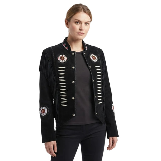 A woman modeling a black suede fringe jacket with silver-toned buttons and circular embroidered details on the chest and sleeves, paired with a dark top and black pants against a white studio background.