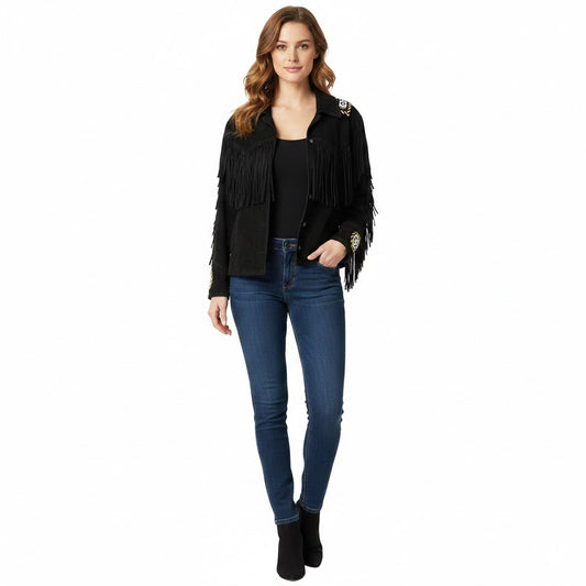 Woman wearing a black fringed jacket, black top, and blue jeans on a white background