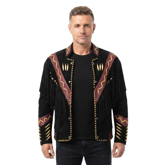 A man wearing a black suede fringe jacket with brown and gold geometric trim and decorative details, paired with a black t-shirt and dark jeans, against a plain white background.