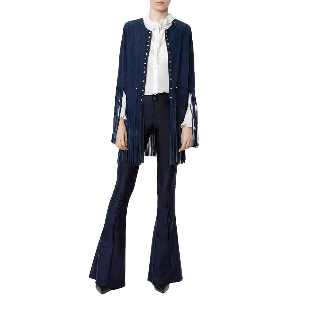 Person wearing a navy blue fringe jacket, white blouse, and black flared pants on a white background