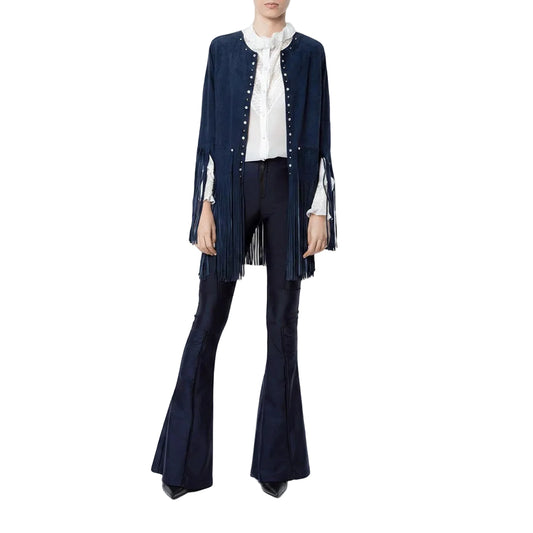 Person wearing a navy blue fringe jacket, white blouse, and black flared pants on a white background