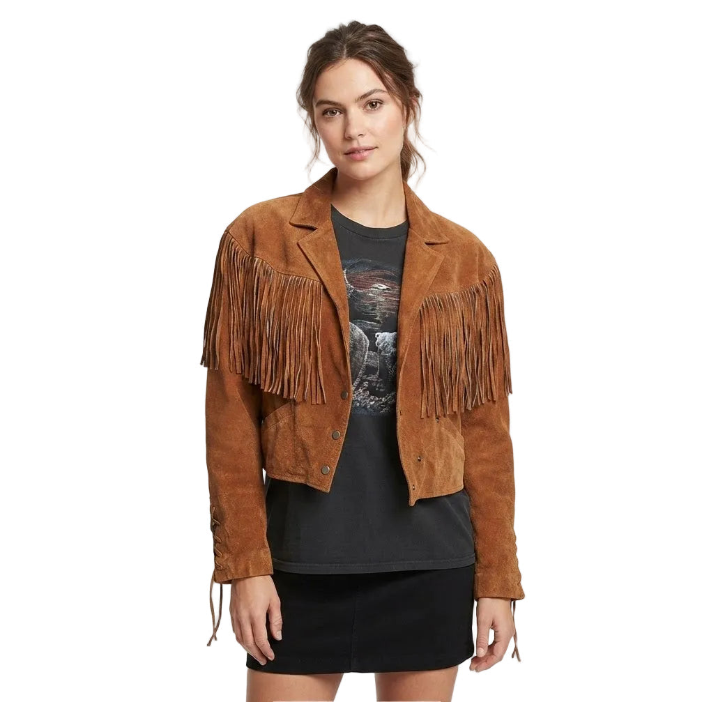 A woman modeling a cropped brown suede fringe jacket over a black graphic t-shirt and black skirt, photographed against a white background.