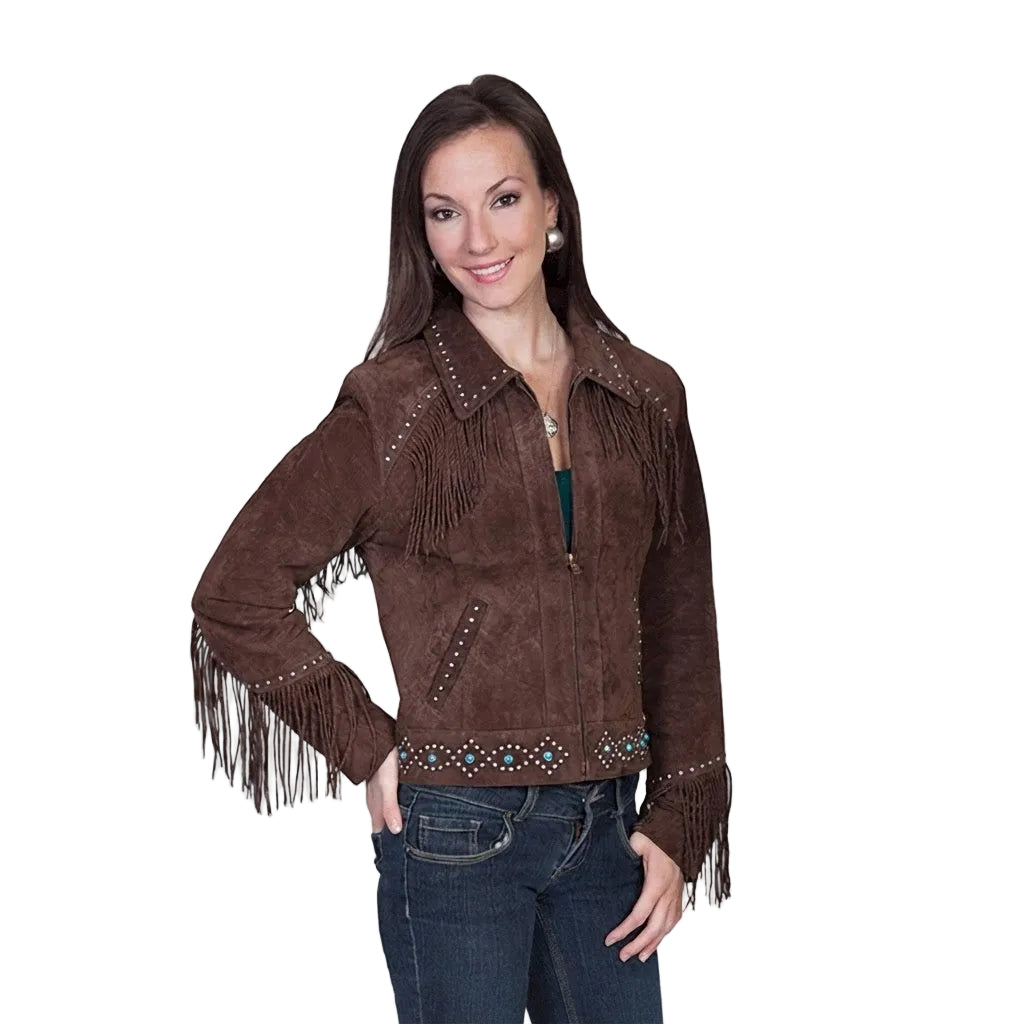 A woman modeling a brown suede fringe jacket with beaded trim, paired with blue jeans, against a plain white background.