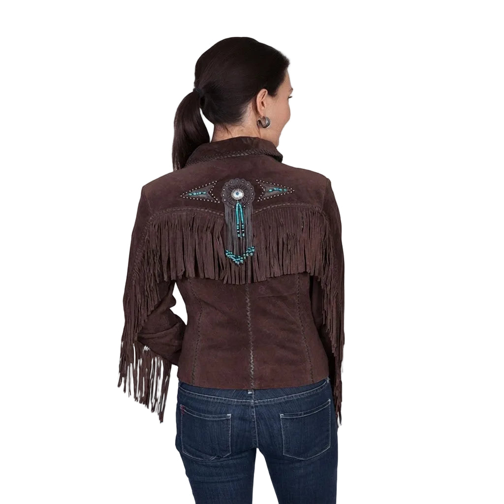 A woman viewed from the back wearing a dark brown suede fringe jacket with turquoise and silver beadwork across the shoulders, paired with dark blue jeans, against a plain white studio background.