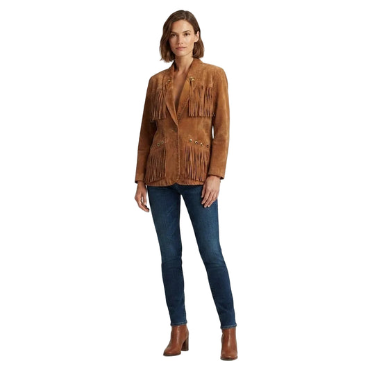 A woman modeling a brown suede fringe jacket, paired with dark blue skinny jeans and brown leather ankle boots, against a solid white background.