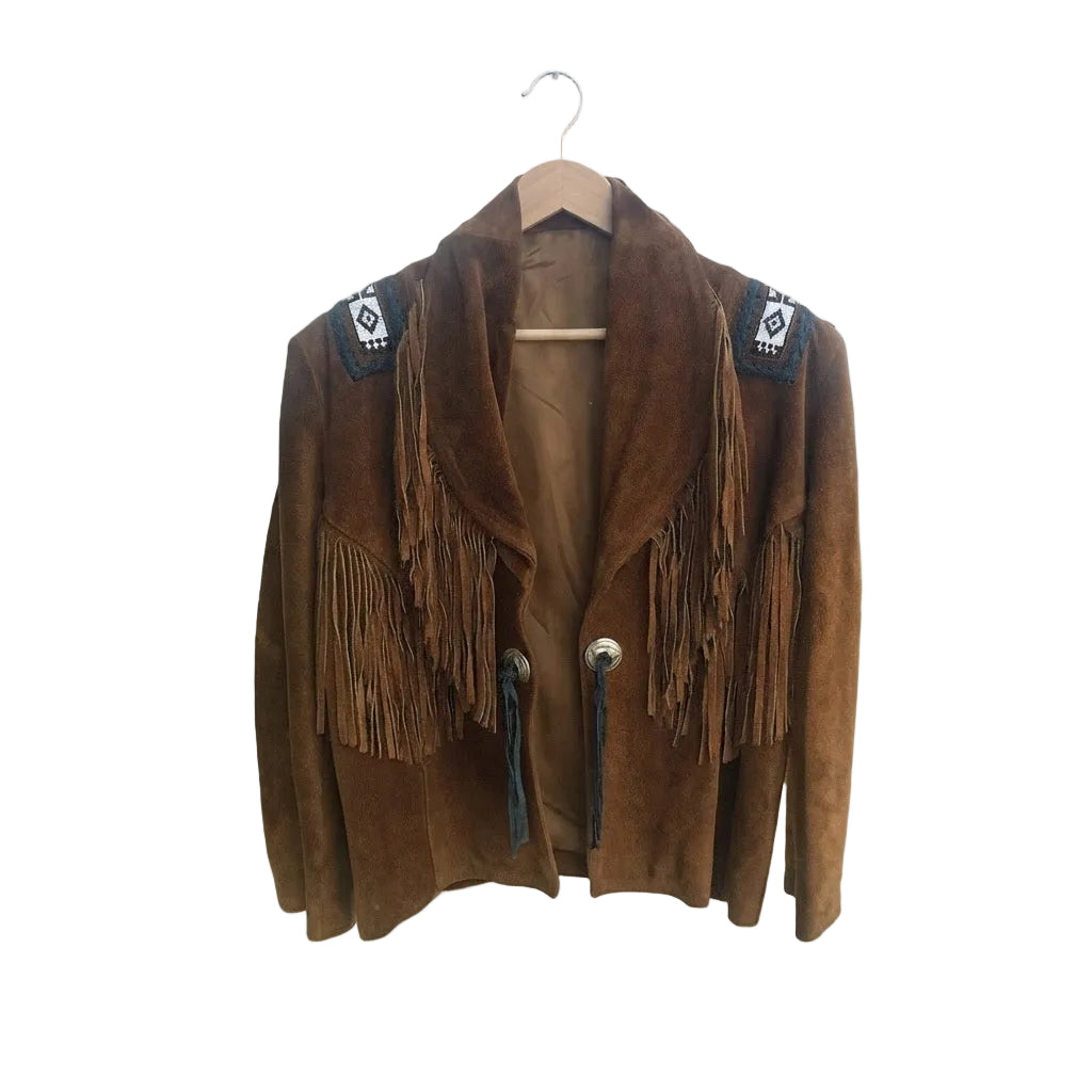 A brown suede fringe jacket with decorative embroidered shoulder patches, hanging on a wooden hanger against a white background.
