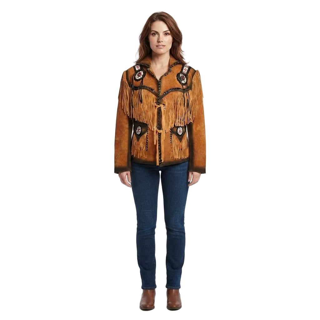 A woman modeling a brown suede western-style jacket with black fringe, embroidered details, and silver-toned conchos, paired with dark blue jeans and brown boots, against a plain white studio background.