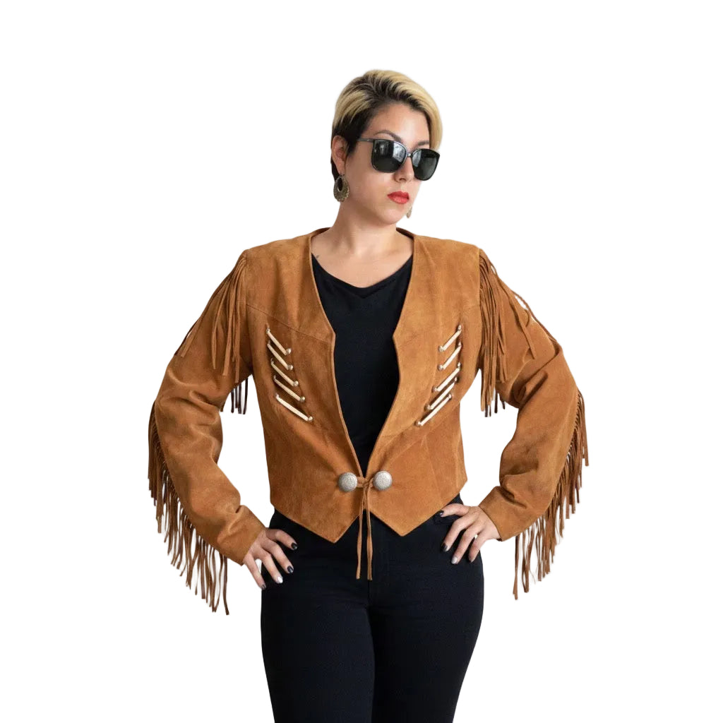 A woman modeling a cropped brown suede fringe jacket with decorative white and brown stripe details on the front, styled over a black top and black pants against a plain white background.