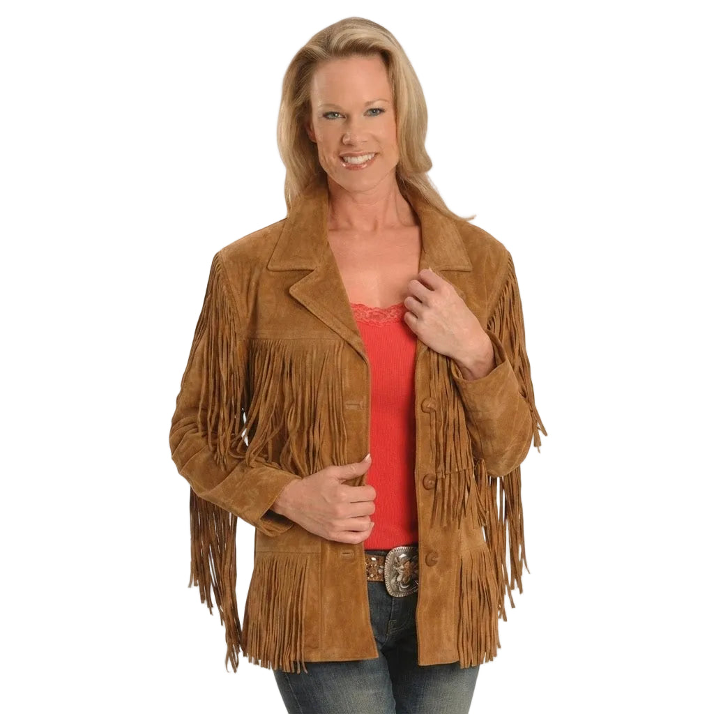 A woman modeling a brown suede fringe jacket over a coral top and jeans, photographed against a plain white studio background.