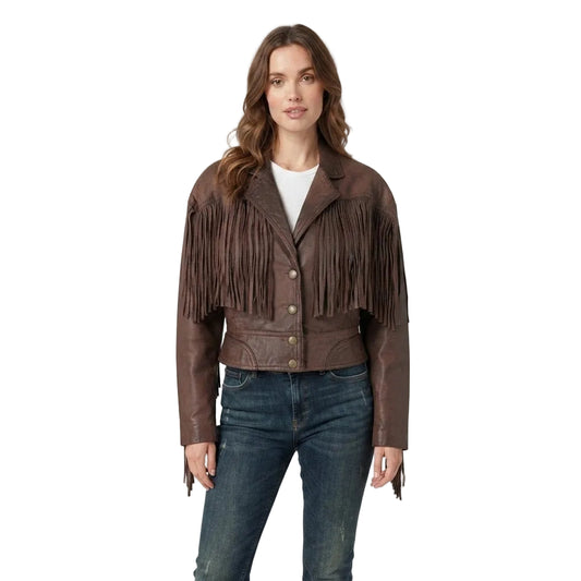 A woman modeling a dark brown leather fringe jacket with worn over a white top and blue jeans, against a plain white background.