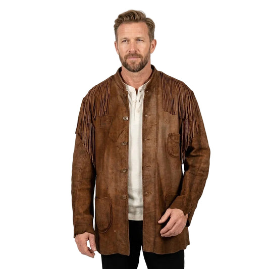 A man wearing a brown suede fringe jacket over a cream shirt and black pants, standing against a plain white studio background.