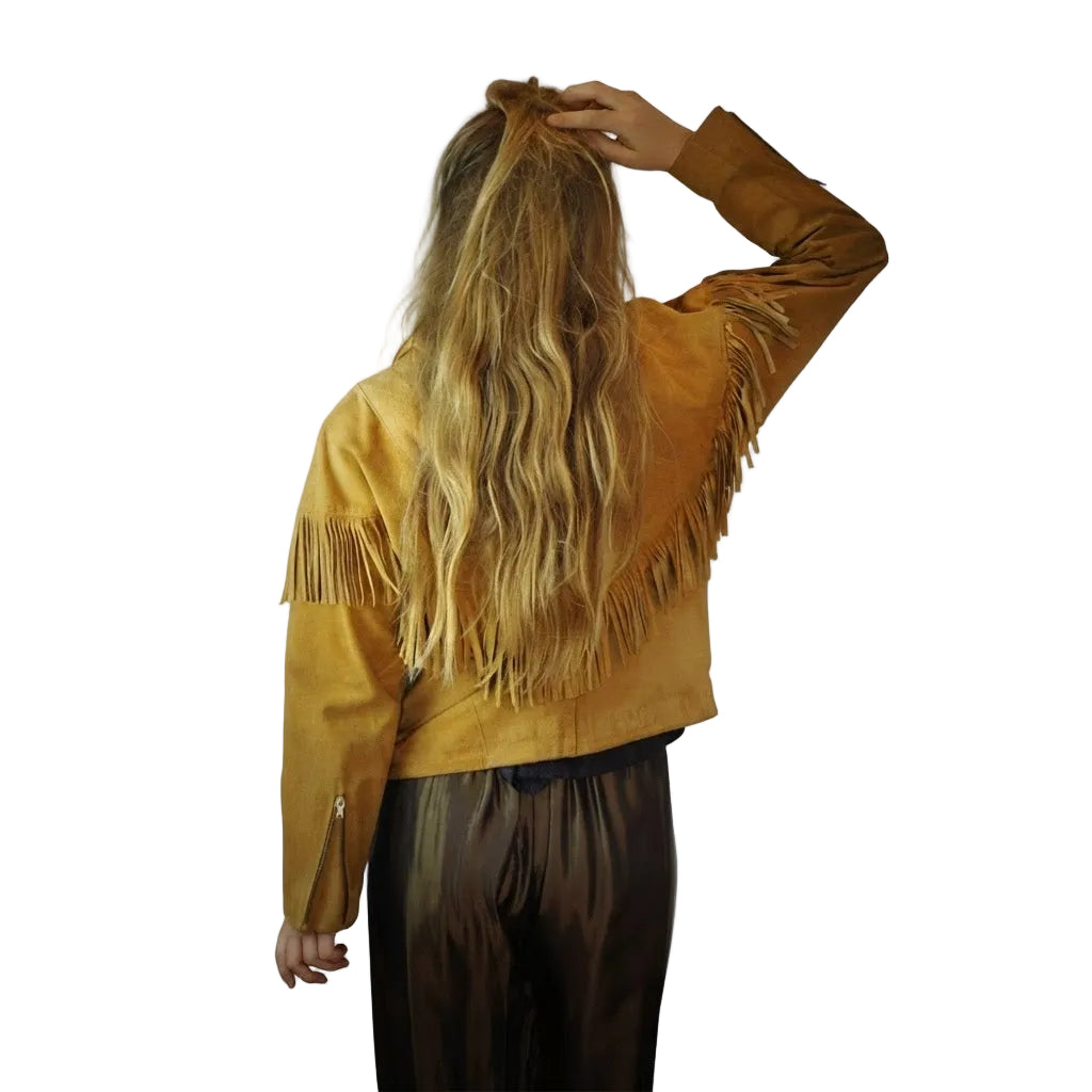 Woman wearing a Tan yellow suede jacket with fringe on a white background 