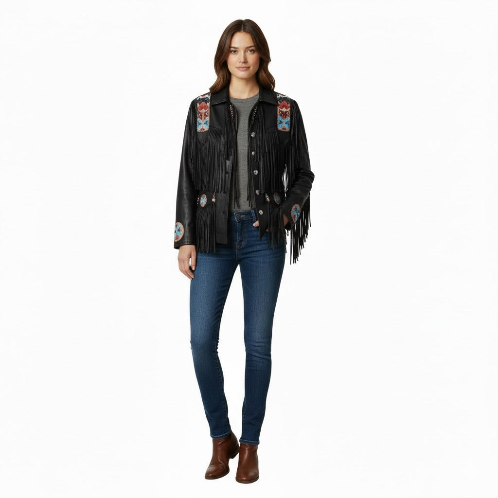 Woman wearing a black fringed jacket with colorful patches on a white background