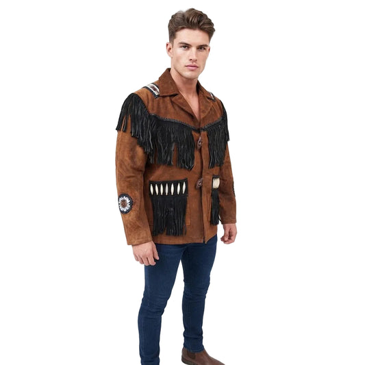 A man modeling a brown suede western-style jacket with black fringe, decorative beadwork, and a fringed chest pocket, paired with dark blue jeans and brown boots against a white studio background.