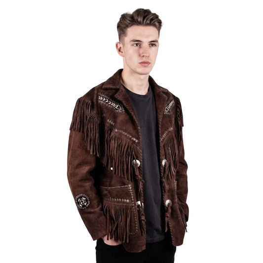 A young man wearing a dark brown suede fringe jacket with western-style embroidery and silver-tone buttons, layered over a black t-shirt, against a plain white studio background.